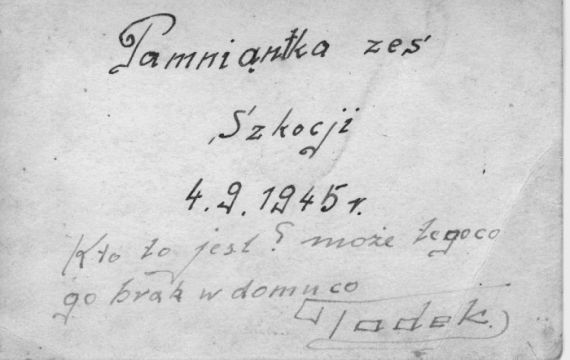 Reverse side of Tad standing guard next to his truck