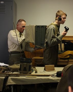 As is evidenced by the photo, the radio set weighs about half of the body mass of Drag. Petronis. We attempted to order a pizza but apparently nobody was listening on that frequency.